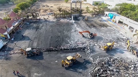 Debris being removed from the game zone site where a fire broke out on Saturday, in Rajkot, Monday.