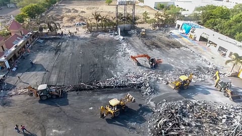Debris being removed from the game zone site where a fire broke out on Saturday, in Rajkot, Monday.