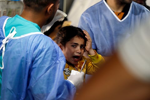 Palestinian medics treat a girl wounded in the Israeli bombardment of the Gaza Strip at the Kuwaiti Hospital in Rafah refugee camp, southern Gaza, Tuesday, May 7, 2024.