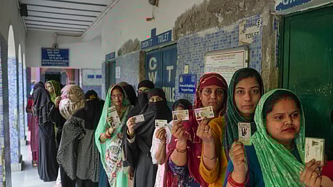 Women wait in queue at a polling station to cast their votes during the sixth phase of Lok Sabha elections, at Trilokpuri, in east Delhi, Saturday, May 25, 2024.