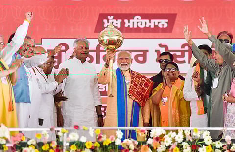 PM Modi with a mace at the Hoshiarpur rally, Punjab.