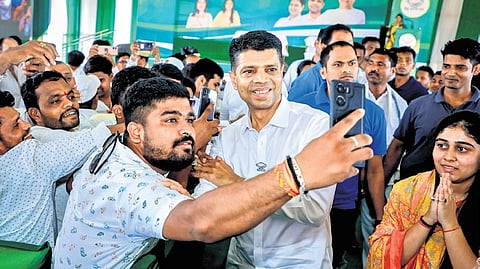 VK Pandian poses for selfie during a public meeting in Ganjam district on Friday