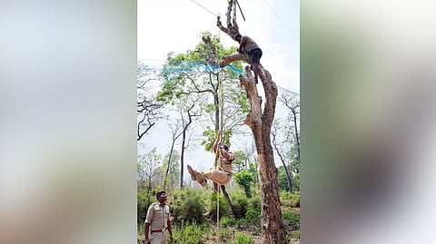 An officer demonstrates use of safety gear during a training session for tribal people.