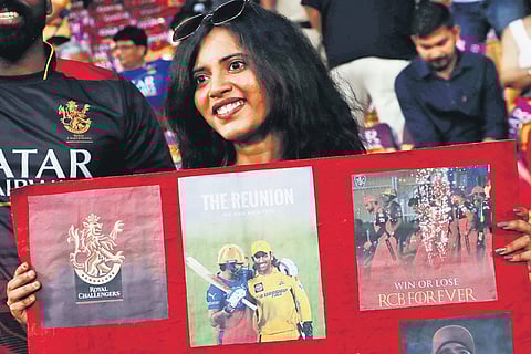 Cricket enthusiasts cheer during the nail-biting match between RCB vs CSK in Bengaluru.