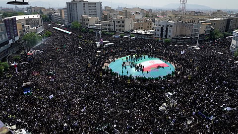 Iranians attend a funeral ceremony for the late President Ebrahim Raisi and his companions who were killed during a helicopter crash on Sunday in a mountainous region of the country's northwest, in Tehran.