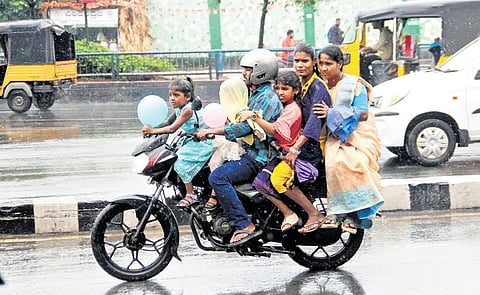 A family caught off-guard in the rain in Visakhapatnam