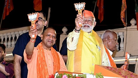 Prime Minister Narendra Modi with Uttar Pradesh Chief Minister Yogi Adityanath during a roadshow ahead of Lok Sabha elections, in Ayodhya