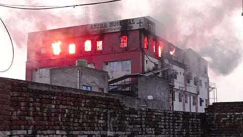 Smoke billows after a fire broke out at a hospital, in Baraut, Monday.