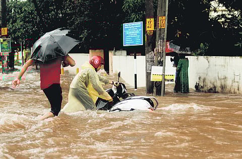 A two-wheeler slips out of hands into the waterlogged Unnichira-Pookattupadi road on Tuesday | Nandan R Nair