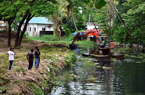 Corporation contract Workers using JCB cleans the Perandoor Canal as part of the pre-monsoon cleaning drive by the Kochi Corporation.