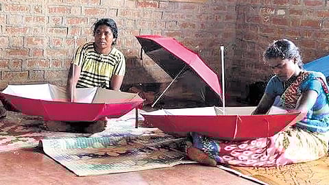 A group of women making Karthumbi umbrellas