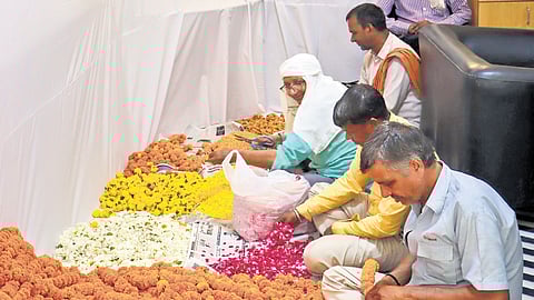 Workers decorate a polling booth for the sixth phase of LS polls on Friday