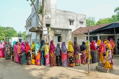 Women stand in a queue to cast their vote at a polling station, during the sixth phase of Lok Sabha elections, in Purba Medinipur district, Saturday, May 25, 2024.