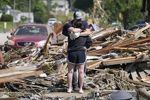 Local residents hug in front of their tornado damaged home, Wednesday, May 22, 2024, in Greenfield, Iowa,