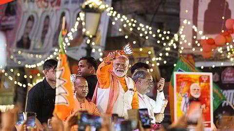 Prime Minister Narendra Modi with Uttar Pradesh Chief Minister Yogi Adityanath during a road show for Lok Sabha elections, in Varanasi, Monday, May 13, 2024