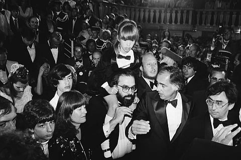 Francis Ford Coppola, center, carries his daughter Sofia, 8, through the crowd after the formal presentation of the US film “Apocalypse Now," at the Cannes International Film Festival in France on May 19, 1979.