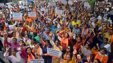 BJP workers stage a protest against jailed Delhi Chief Minister and AAP Chief Arvind Kejriwal, in New Delhi on Tuesday, May 7, 2024.