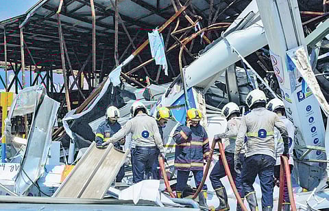 Fire brigade personnel clear the site of the hoarding collapse in Mumbai.