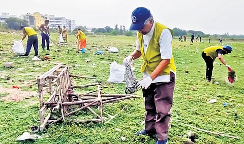Volunteers clear debris from the bed of Kapra lake in Secunderabad