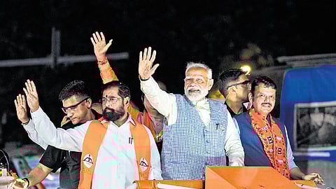 Prime Minister Narendra Modi, Maharashtra Chief Minister Eknath Shinde and Deputy CM Devendra Fadnavis during a roadshow in Mumbai on Wednesday.