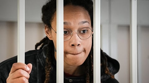 WNBA star and two-time Olympic medalist Brittney Griner speaks to her lawyers from inside a cage in a courtroom in Khimki, outside Moscow, Russia, on July 26, 2022.
