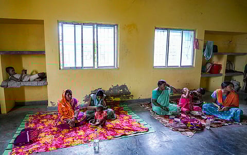 Locals take shelter at a relief camp at Frazerganj of Namkhana ahead of the landfall of Cyclone 'Remal', in South 24 Parganas district.