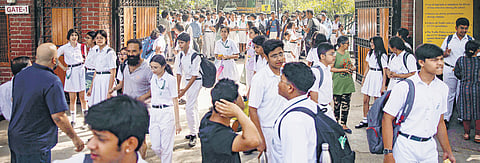 Students come out of premises as a school is evacuated in Noida following threat mail