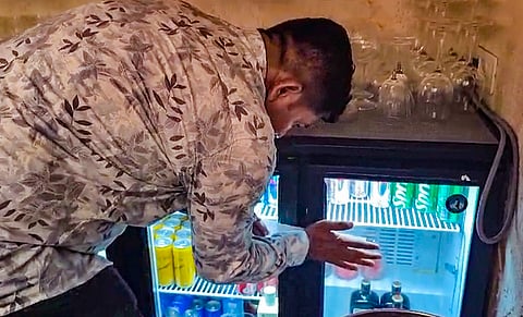 Officials seal the Cosie bar which served liquor to the 17-yr old boy who killed two people in the Kalyan Nagar area of Pune Sunday night.