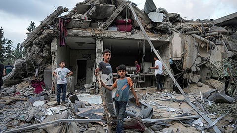 Palestinians look at the destruction after an Israeli airstrike in Deir al Balah, Gaza Strip, Tuesday, April 30, 2024.