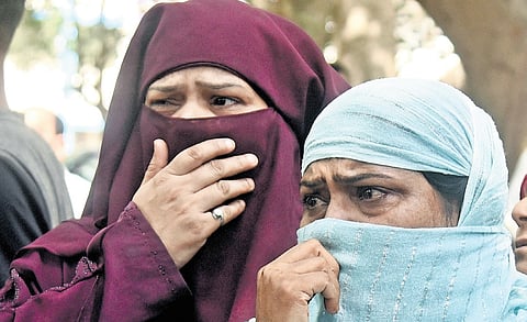 Relatives of infant victims wait to identify bodies outside mortuary