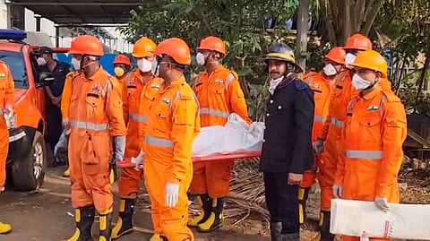 Officials carry a body as th death toll in the chemical factory blast rises to nine with the discovery of one more body from the accident site at Dombivli, in Thane district.
