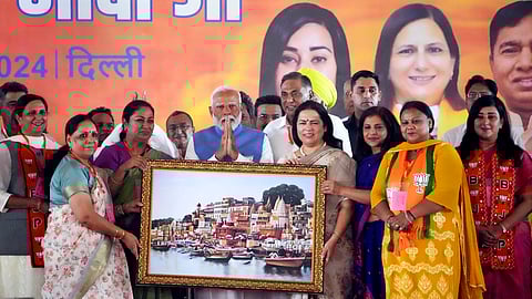 PM Modi being presented a memento during a public meeting in support of BJP candidates, at Dwarka, on Wednesday.