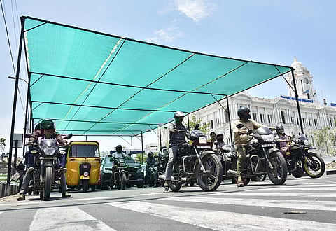 A sun shade with green net being set up at Ripon Building signal in Chennai.