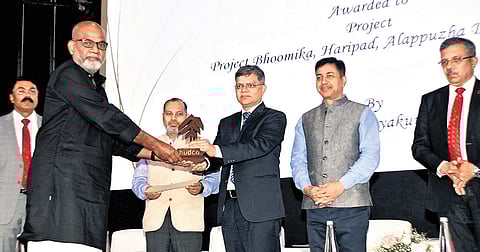Architect N S Abhayakumar receiving HUDCO design award in the category of cost effective rural/urban housing for project Bhoomika, a flood relief housing initiative