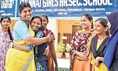 Poongothai, who scored 578 marks in class 12 exams, being congratulated by her teachers and classmates at Chennai Girls Higher Secondary School in Perambur on Monday