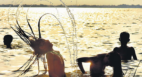 Children enjoying a bath in Puzhal lake in Redhills to beat the heat.