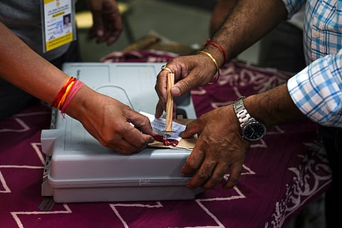 Poll officials seal an EVM at a polling station after the sixth phase of Lok Sabha elections, at Trilokpur, in east Delhi, Saturday, May 25, 2024.