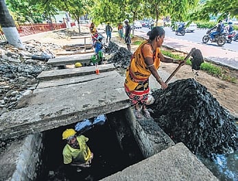 Workers desilting a stormwater drain along Jayadev Vihar - Nandankanan road in Bhubaneswar.