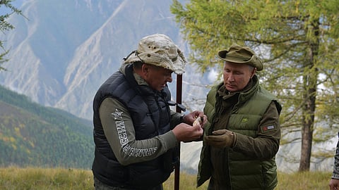 In this pool photograph distributed by Russian state owned Sputnik agency Russian President Vladimir Putin (R) speaks with Defence Minister Sergei Shoigu during their leisure time in the Siberian Taiga area on October 6, 2019.