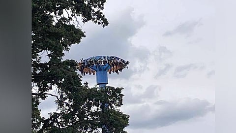 In this photo provided by Tieanna Joseph Cade, an amusement park ride is shown stuck with 30 people trapped upside down in Portland, Ore.