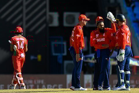Adil Rashid (2R) of England celebrates the dismissal of Mehran Khan (L) of Oman during the ICC Men’s T20 CWC group B match between England and Oman on June 13, 2024.