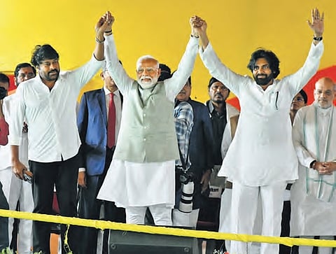 Megastar Chiranjeevi, PM Modi and Jana Sena Party chief Pawan Kalyan greet the gathering at Kesarapalli near Vijayawada on Wednesday