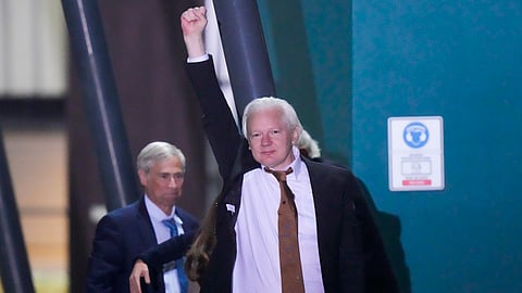 WikiLeaks founder Julian Assange waves after landing at RAAF air base Fairbairn in Canberra, Australia, Wednesday, June 26 2024.