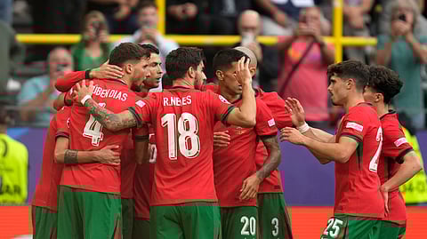 Portugal players celebrate after Bruno Fernandes scored his side's third goal during a Group F match between Turkey and Portugal at the Euro 2024 soccer tournament in Dortmund, Germany, Saturday, June 22, 2024.