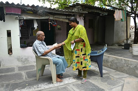 Village and Ward Secretariat staff handover social security pension to physically challenged beneficiaries at their doorstep in Vijayawada on Saturday.