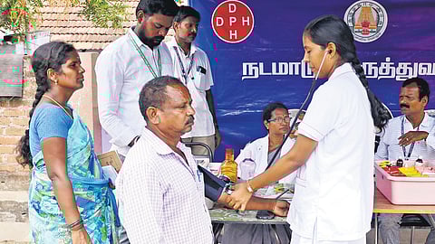 A medical officer at the Karunapuram camp attending to a patient showing symptoms of methanol poisoning on Friday
