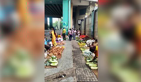 Street vendors occupy the footpaths on both sides of the Banashankari Temple road