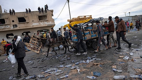 Palestinians loot a humanitarian aid truck as it crossed into the Gaza Strip in Rafah.