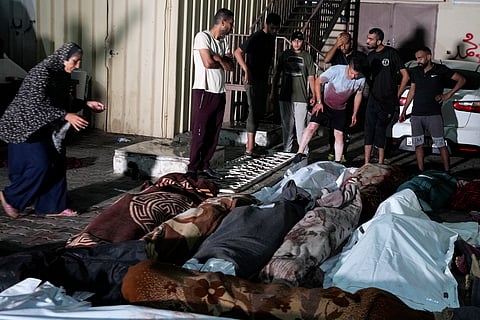 Palestinians mourn their relatives killed in an Israeli bombardment of UNRWA school at Nusseirat refugee camp, in front of the morgue of al-Aqsa Martyrs hospital in Deir al-Balah, central Gaza Strip, early Thursday, June 6, 2024.