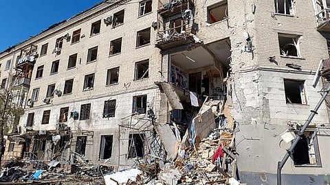 In this photo provided by the Ukrainian Emergency Service, rescuers work in a damaged apartment house after it was hit by Russian air bomb killing at least three and injuring 23, in Kharkiv, Ukraine, Saturday.